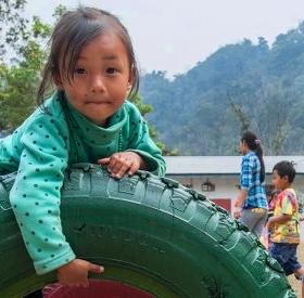A girl of 4 plays in the school yard before the start of class. Save the Children is working with pr A girl of 4 plays in the school yard before the start of class. Save the Children is working with pr