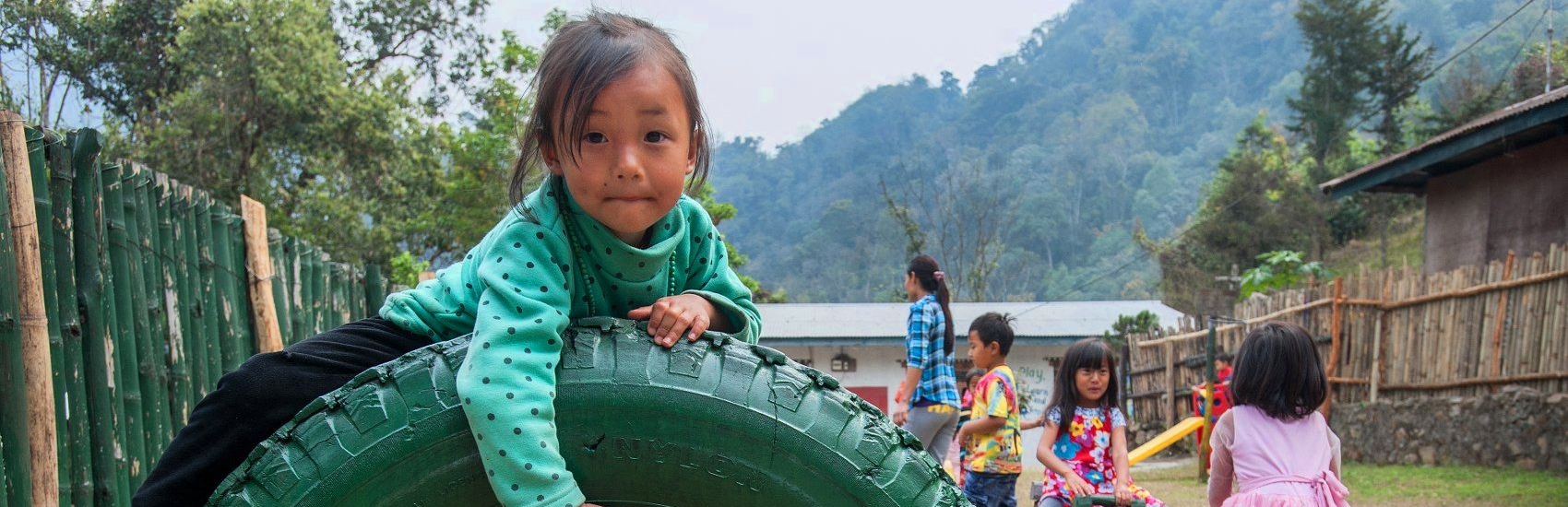 A girl of 4 plays in the school yard before the start of class. Save the Children is working with pr