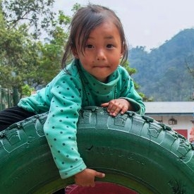 A girl of 4 plays in the school yard before the start of class. Save the Children is working with pr