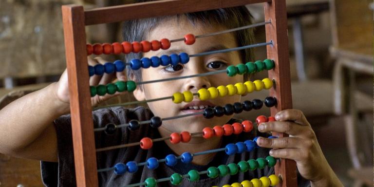 A young boy using an abacus from Learning Corner Program in his 1st grade class. A young boy using an abacus from Learning Corner Program in his 1st grade class.