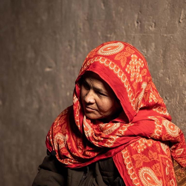 In Afghanistan, a mother sits in her home in a displacement camp following the death of her husband. In Afghanistan, a mother sits in her home in a displacement camp following the death of her husband.