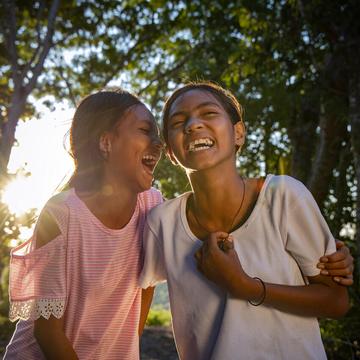 Two girls hugging and laughing Two girls hugging and laughing