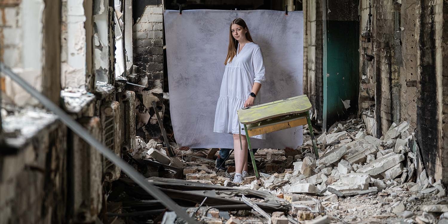 Ukraine, a teenage girl stands in the rubble of what used to be her school. Ukraine, a teenage girl stands in the rubble of what used to be her school.