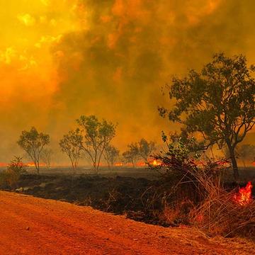 An empty dirt road reflects the red blaze of the enormous and unprecedented Australian bush fires. Smoke and flames appear in the distance, while parts of the horizon are actively burning. Save the Children is helping children and families in Australia who have been impacted by the fires. Photo credit: John Crux Photography. An empty dirt road reflects the red blaze of the enormous and unprecedented Australian bush fires. Smoke and flames appear in the distance, while parts of the horizon are actively burning. Save the Children is helping children and families in Australia who have been impacted by the fires. Photo credit: John Crux Photography.