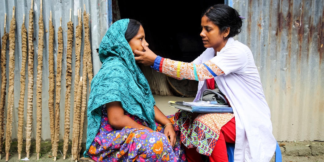 A doctor examines a young woman.