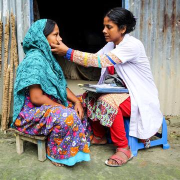 Bangladesh doctor making a house call and providing consultation. Bangladesh doctor making a house call and providing consultation.