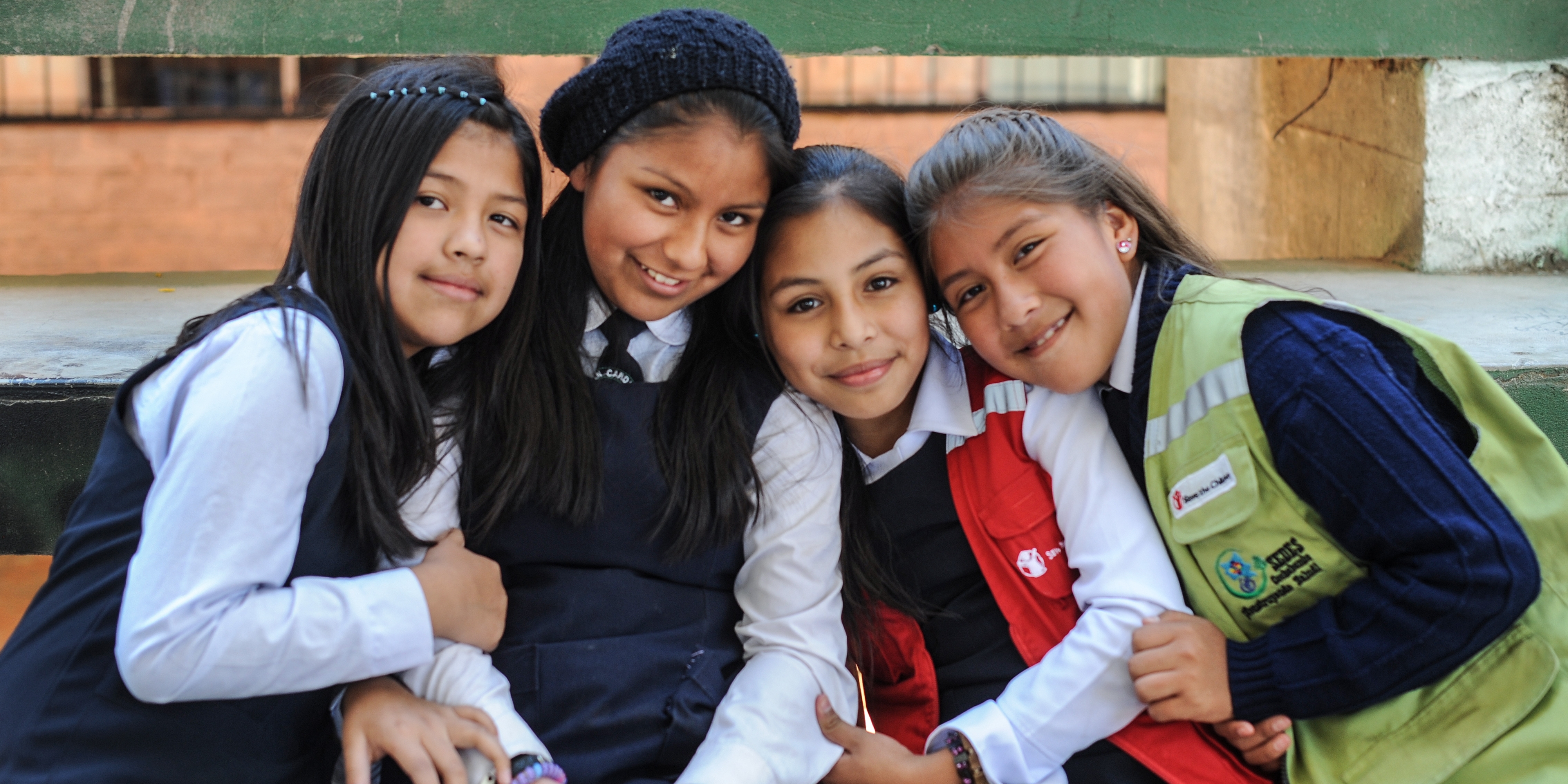 Girls pose for a photograph at a school supported by Save the Children sponsorship programs. Save the Children is working hard in Bolivia to help kids stay healthy and stay in school through sponsorship programs at local elementary schools and early education centers. Photo Credit: Susan Warner/Save the Children 2015.