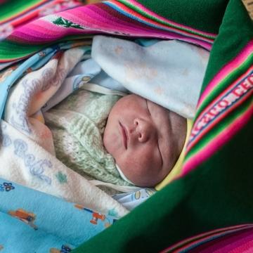 Healthy newborn Emanuel, a brand new, one-day-old baby, here in his colorful aguayo, and his mother Liseth are alive and thriving, thanks to your support of our vital work in Bolivia. Photo Credit: Susan Warner/Save the Children 2015. Healthy newborn Emanuel, a brand new, one-day-old baby, here in his colorful aguayo, and his mother Liseth are alive and thriving, thanks to your support of our vital work in Bolivia. Photo Credit: Susan Warner/Save the Children 2015.