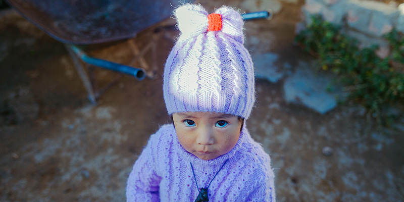 Save the Children helped two-year-old Marian's mother to set up a knitting business in Bolivia.