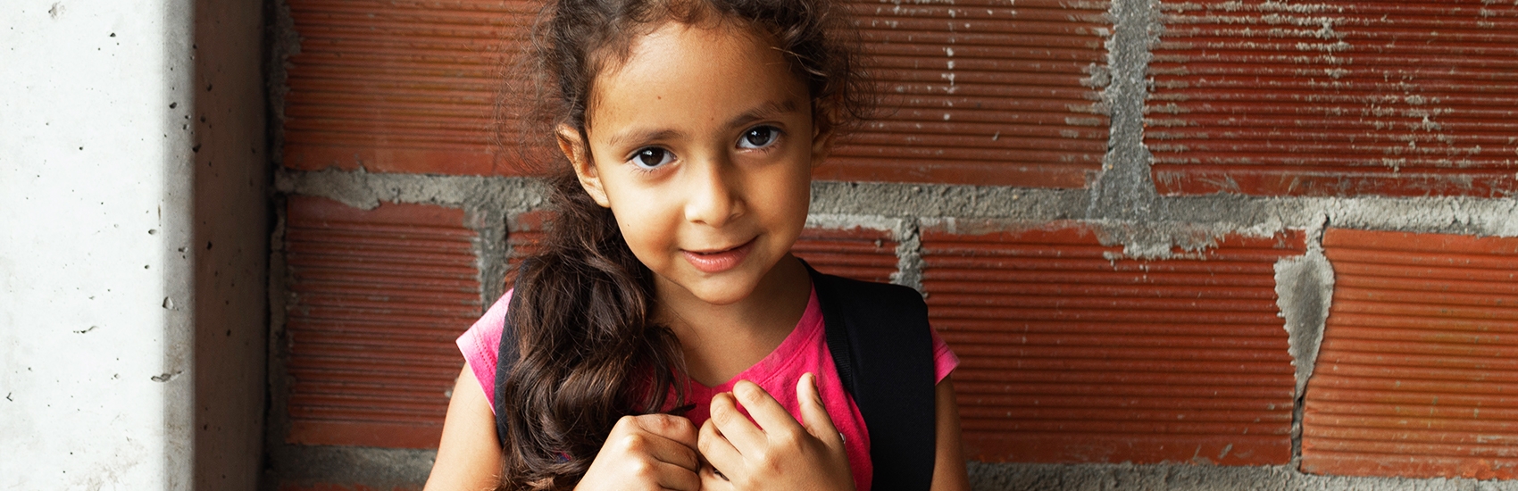 Colombia, a little in a pink shirt smiles.