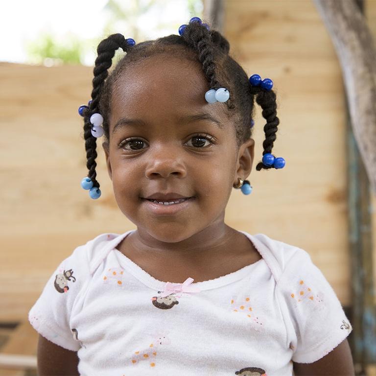 A young girl smiles for the camera A young girl smiles for the camera