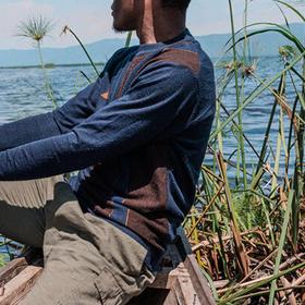 17-year-old Junior*, who spent eight months as a child solider in an armed group in 2018, sits in a canoe nearby his community in Eastern DRC. 17-year-old Junior*, who spent eight months as a child solider in an armed group in 2018, sits in a canoe nearby his community in Eastern DRC.