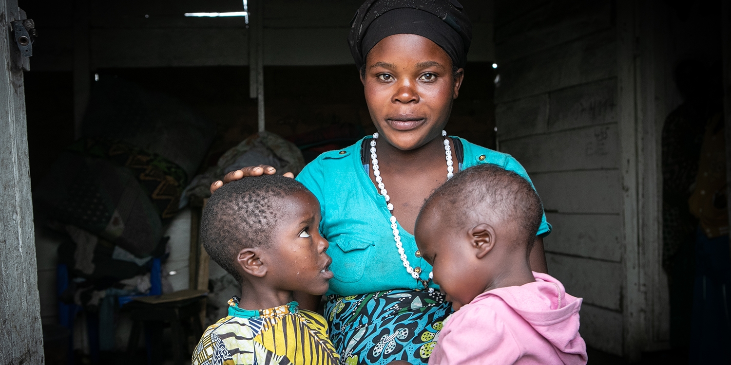 DRC, a single mother sits with her two children DRC, a single mother sits with her two children