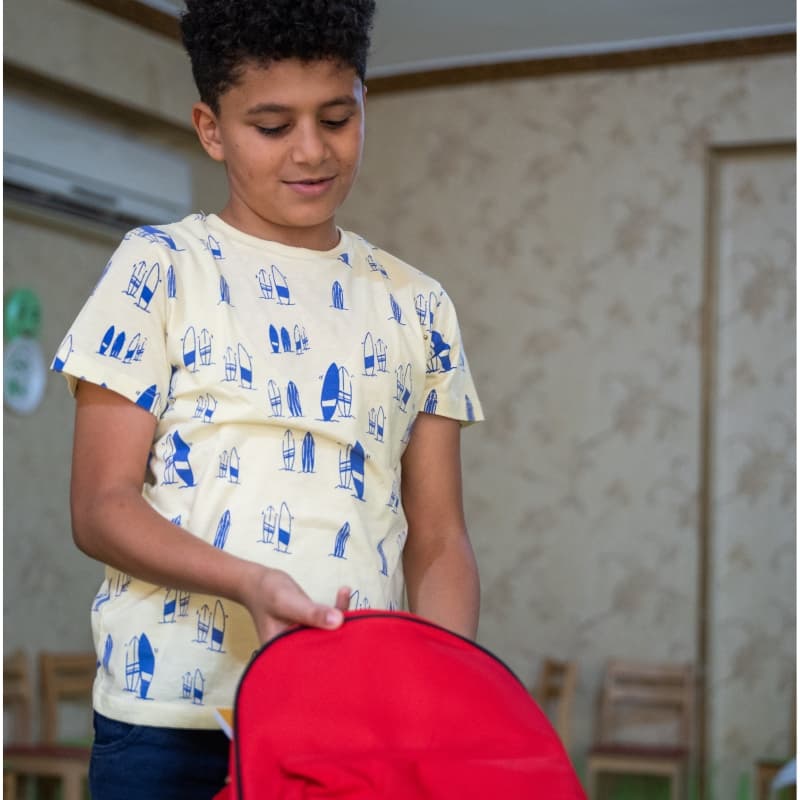 11-year-old boy opens his school bag in Egypt 11-year-old boy opens his school bag in Egypt
