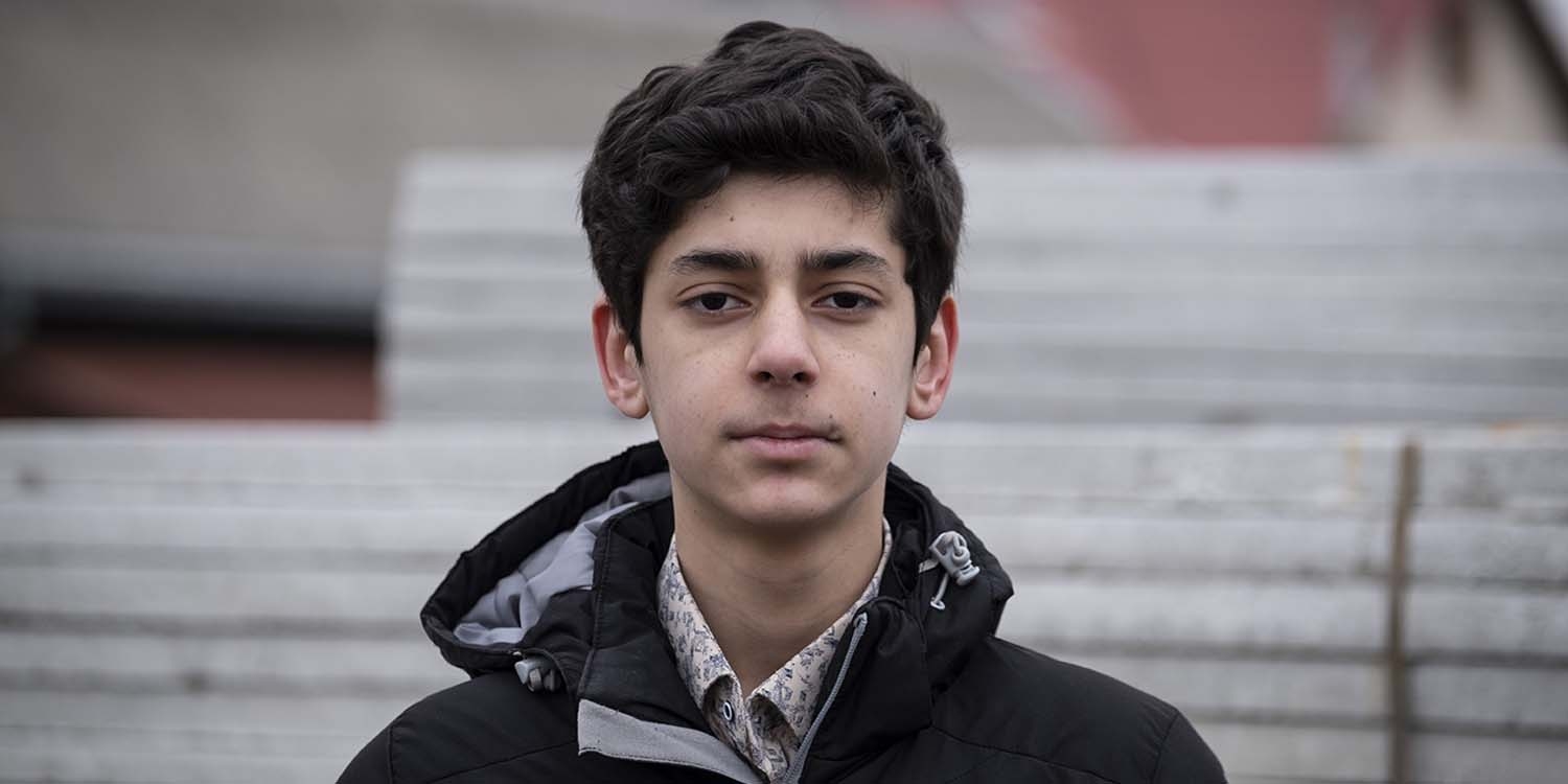 Afghanistan, a 14 year old boy in a black jacket looking straight to the camera Afghanistan, a 14 year old boy in a black jacket looking straight to the camera