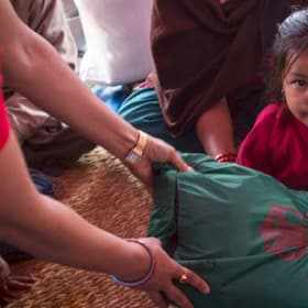 A girl from Nepal sits in her home A girl from Nepal sits in her home