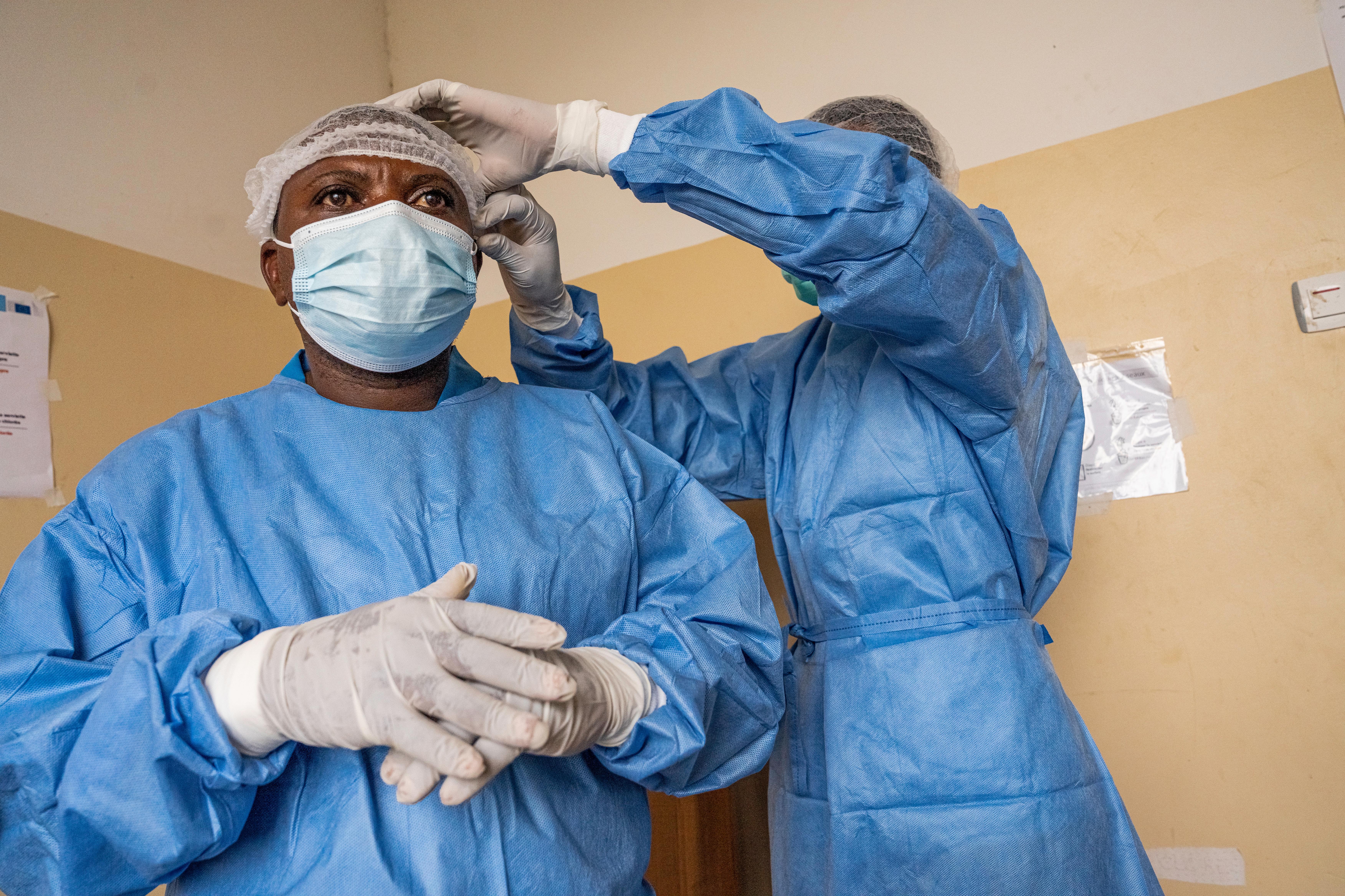Health workers put on protective gear during an Ebola outbreak