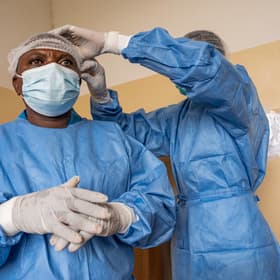 Health workers put on protective gear during an Ebola outbreak Health workers put on protective gear during an Ebola outbreak