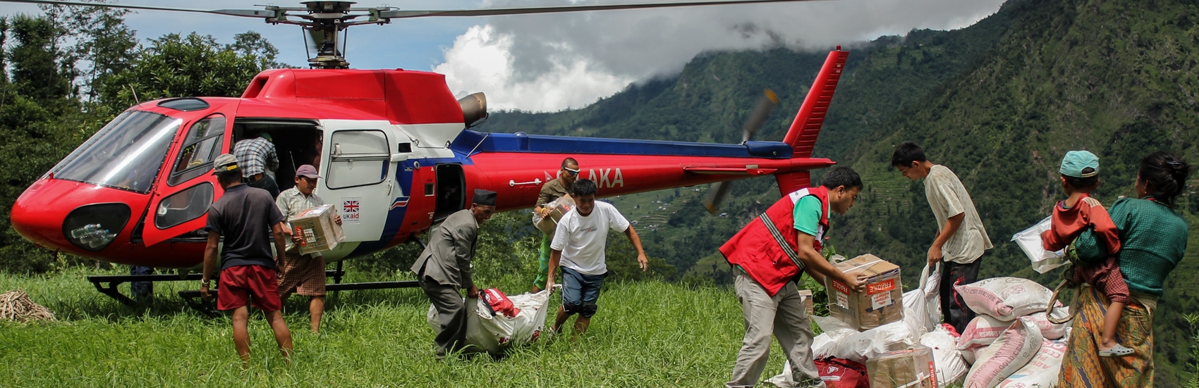 Helicopter discharge of Save the Childrens shelter and WASH assistance material by staff members and