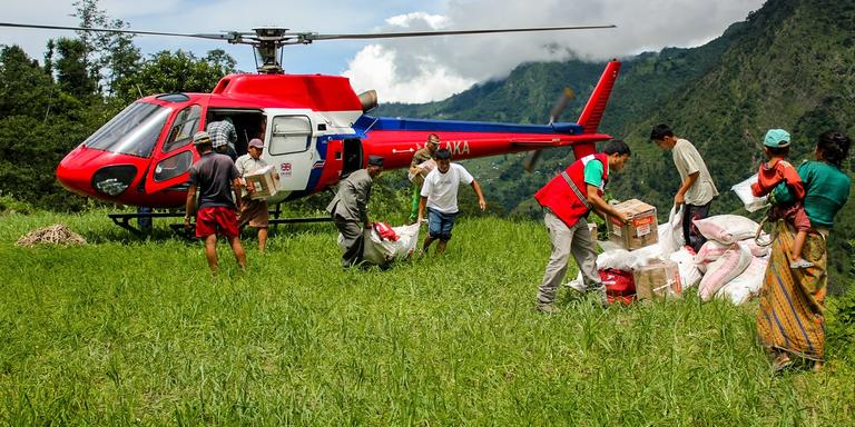Helicopter discharge of Save the Childrens shelter and WASH assistance material by staff members and Helicopter discharge of Save the Childrens shelter and WASH assistance material by staff members and