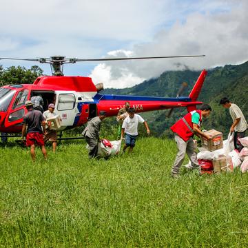 Helicopter discharge of Save the Childrens shelter and WASH assistance material by staff members and Helicopter discharge of Save the Childrens shelter and WASH assistance material by staff members and