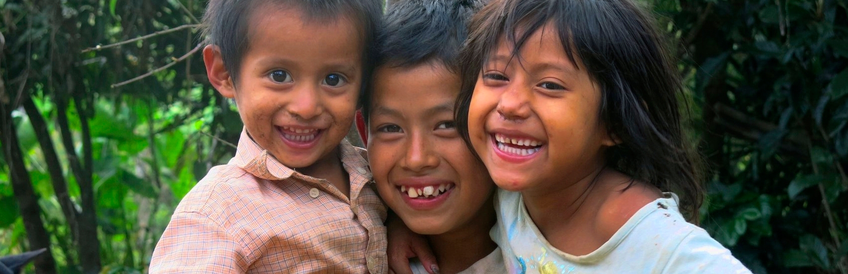 Kevin (age 11) with two of his seven siblings. The nine children are being raised by a single mother, their father left. Kevin is no longer at school as his mother can’t afford the costs. He helps his mother when he can, picking tomatoes or cutting coffee if they can find work due to the coffee rust – a blight that is killing coffee plants. The younger siblings are losing weight; the youngest has severe diarrhea due to poor hygiene and no sanitation. Save the Children Honduras is helping this family with ba