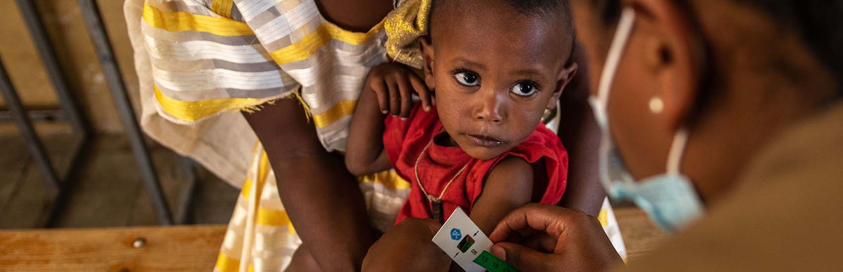 In Tigray, a child is screened for malnutrition. 