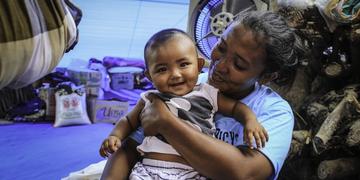 Mother and baby smile despite living in an evacuation camp because of the the earthquake in Indonesia in 2018. Mother and baby smile despite living in an evacuation camp because of the the earthquake in Indonesia in 2018.