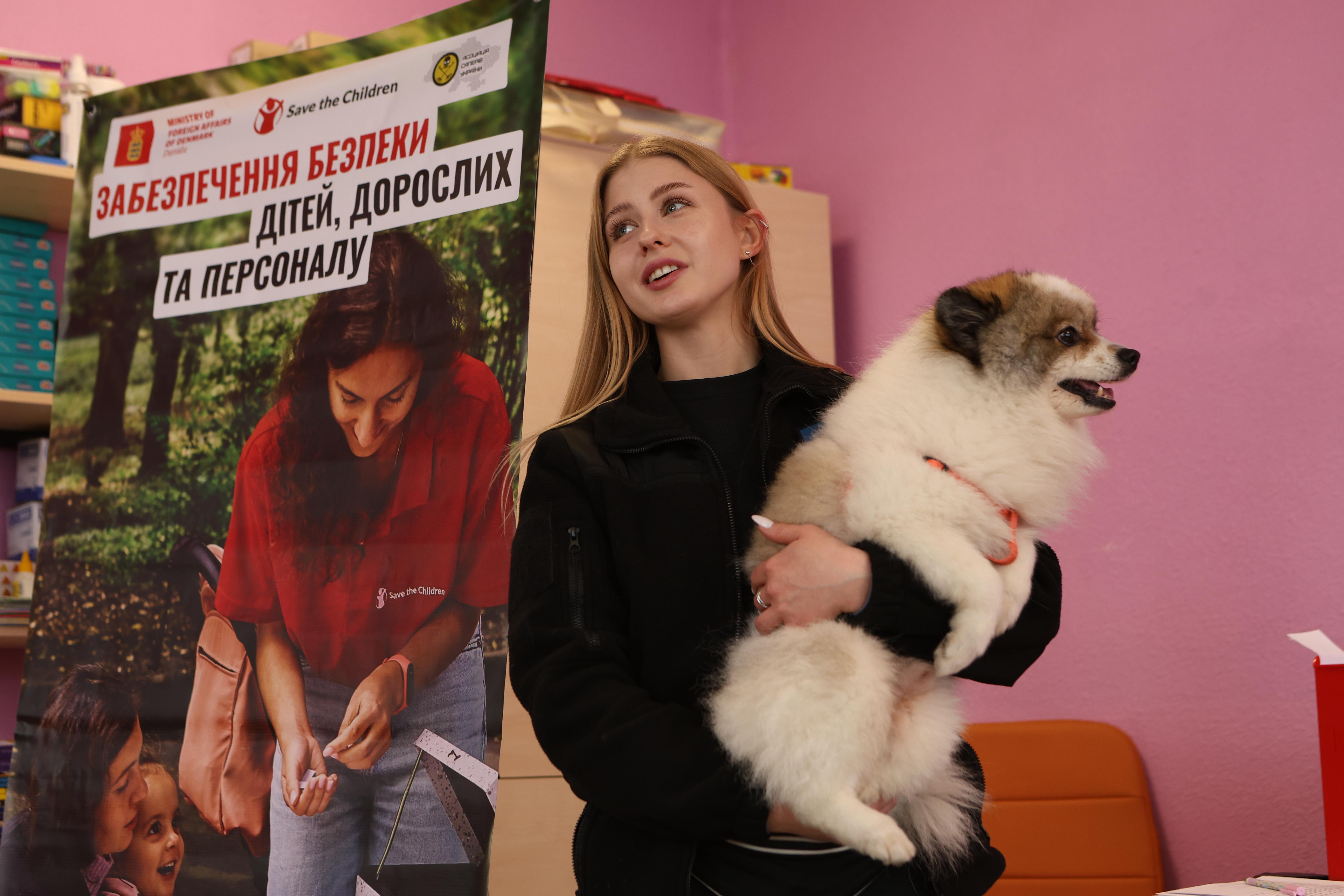 Instructors from the Ukrainian Deminers Association with Chivas, a demining dog