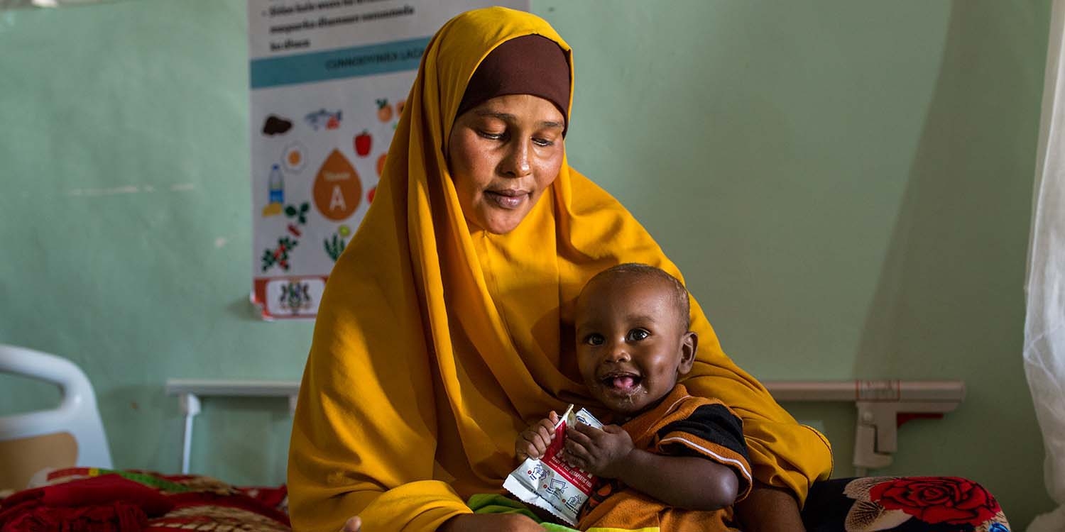 Somalia a 10-month-old baby is cradled by his mother after receiving therapeutic food Somalia a 10-month-old baby is cradled by his mother after receiving therapeutic food