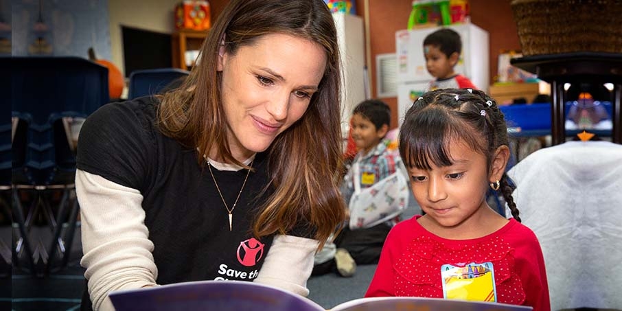 Jennifer Garner, actor and Save the Children Trustee, reads with a child. Jennifer Garner, actor and Save the Children Trustee, reads with a child.