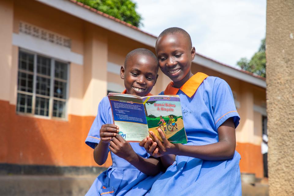 Jennifer (left) and Sarah (right) reading a book Jennifer (left) and Sarah (right) reading a book