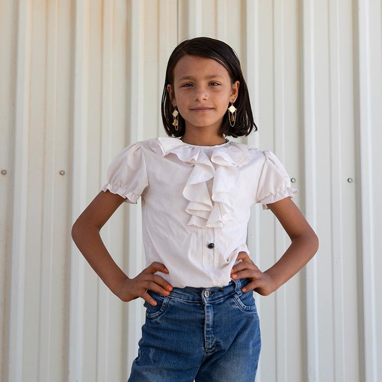 A girl stands with her hands on her hips at the Girls Empowerment Center in Jordan A girl stands with her hands on her hips at the Girls Empowerment Center in Jordan