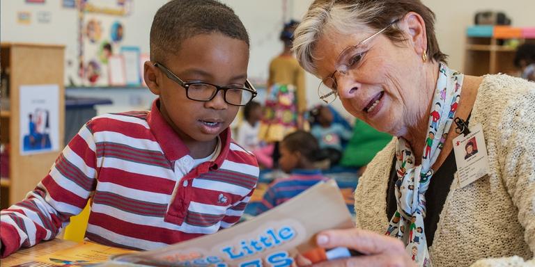 Judie Jerald, Save the Children Senior Advisor for Early Childhood Education policy reads to a stude Judie Jerald, Save the Children Senior Advisor for Early Childhood Education policy reads to a stude