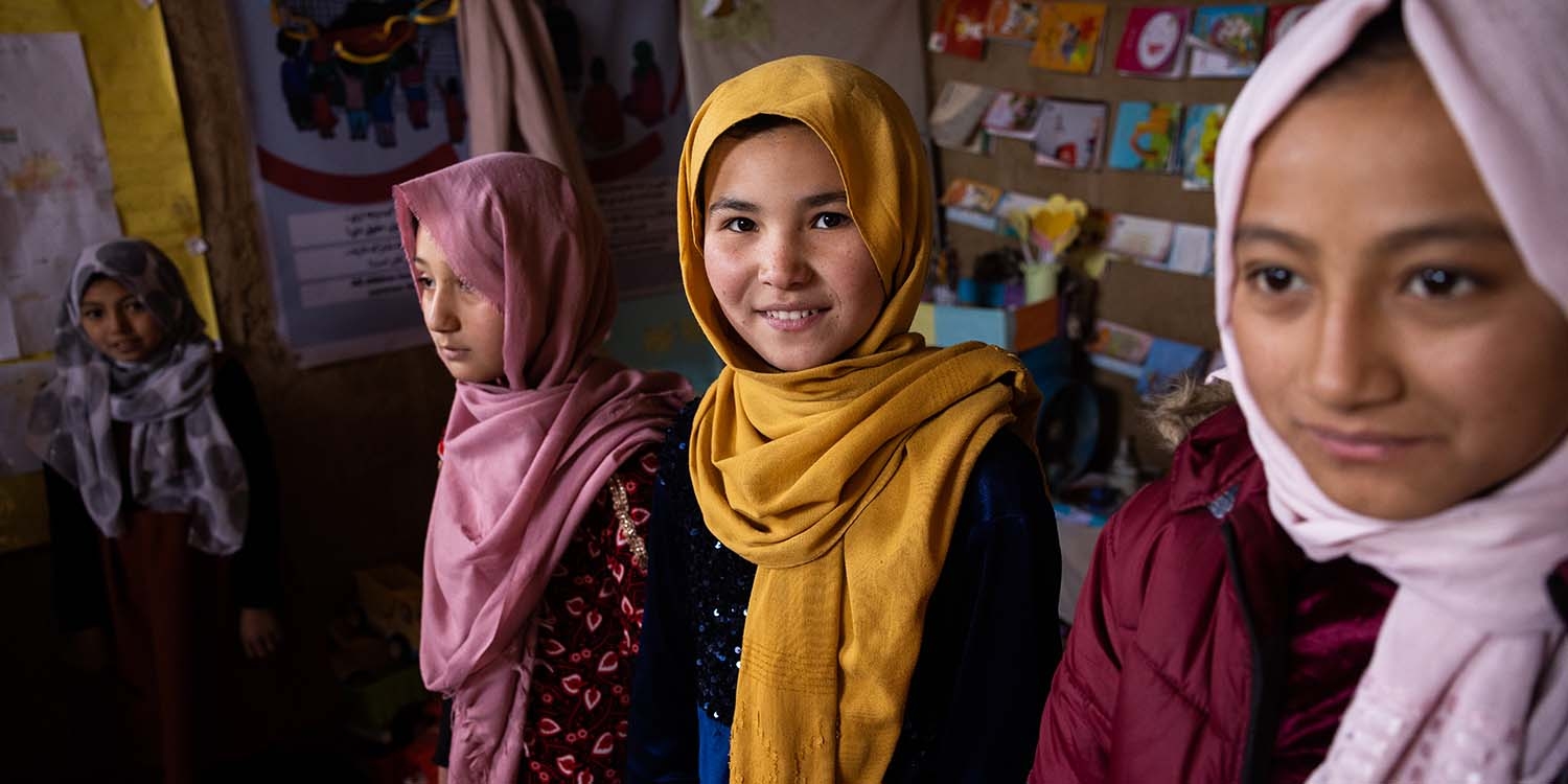Afghanistan, four girls in colorful hijabs in a displacement camp Afghanistan, four girls in colorful hijabs in a displacement camp