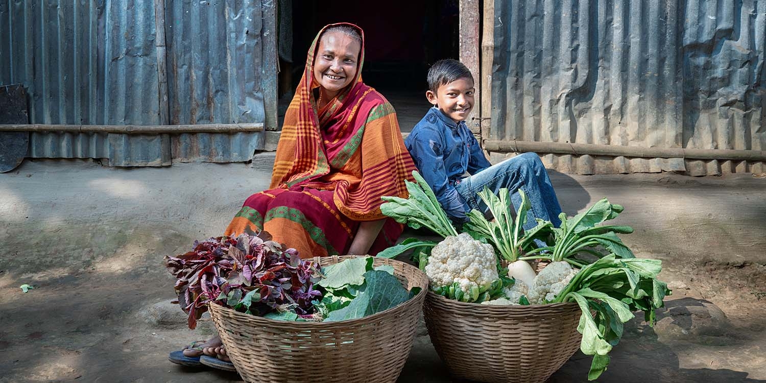 Bangladesh, a mother and son show off their home-grown vegetables Bangladesh, a mother and son show off their home-grown vegetables