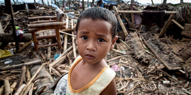 Kirby, four, stands amongst the debris where his house once stood before it was destroyed by typhoon Kirby, four, stands amongst the debris where his house once stood before it was destroyed by typhoon