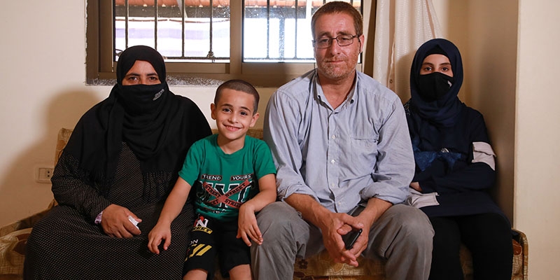 The family sits together on a couch in their home in Beirut. The family sits together on a couch in their home in Beirut.