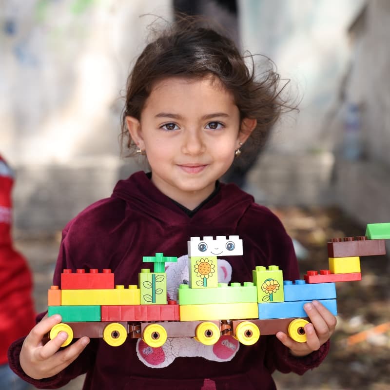Little girl plays with toy in child friendly space in Lebanon Little girl plays with toy in child friendly space in Lebanon