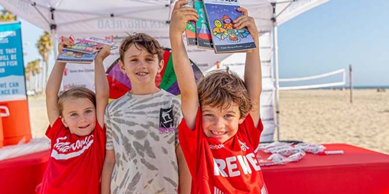 Kids show off Mad Lib books they received during the launch event for Save the Children’s annual summer reading campaign at Santa Monica beach in Los Angeles, California. Kids show off Mad Lib books they received during the launch event for Save the Children’s annual summer reading campaign at Santa Monica beach in Los Angeles, California.