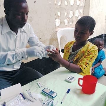 A child recieves malaria treatment from a doctor. A child recieves malaria treatment from a doctor.