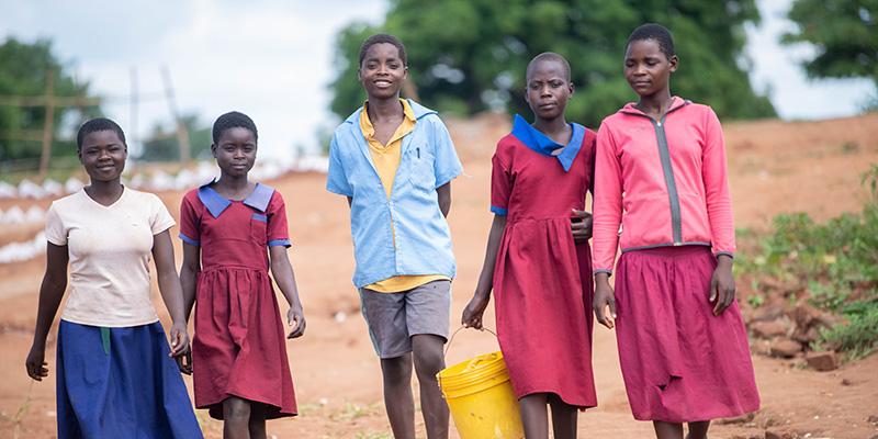 Teenagers walking home from school together in Malawi