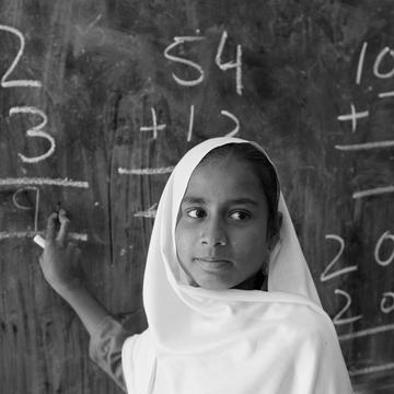 A young student doing math sums on the blackboard in class 3 in a government girls school in Khyber Pakhtunkhwa Province, Pakistan. Photo Credit: Asad Zaidi/Save the Children 2014. A young student doing math sums on the blackboard in class 3 in a government girls school in Khyber Pakhtunkhwa Province, Pakistan. Photo Credit: Asad Zaidi/Save the Children 2014.