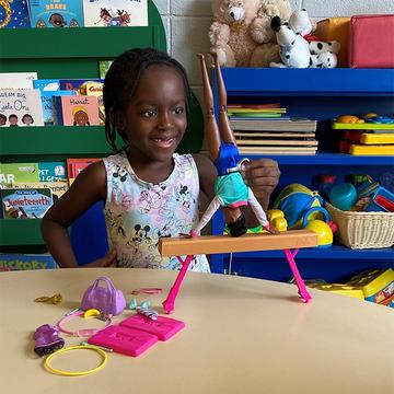 A little girl plays with a Barbie doll from Mattel A little girl plays with a Barbie doll from Mattel