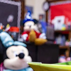 An 8-year-old boy in a navy-blue shirt reads with in a Save the Children room. An 8-year-old boy in a navy-blue shirt reads with in a Save the Children room.