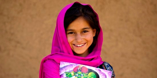 A 9 year-old girl with a story book outside her home in her village in Khyber Pakhtunkhwa Province, Pakistan. Photo Credit: Asad Zaidi/Save the Children 2014. A 9 year-old girl with a story book outside her home in her village in Khyber Pakhtunkhwa Province, Pakistan. Photo Credit: Asad Zaidi/Save the Children 2014.