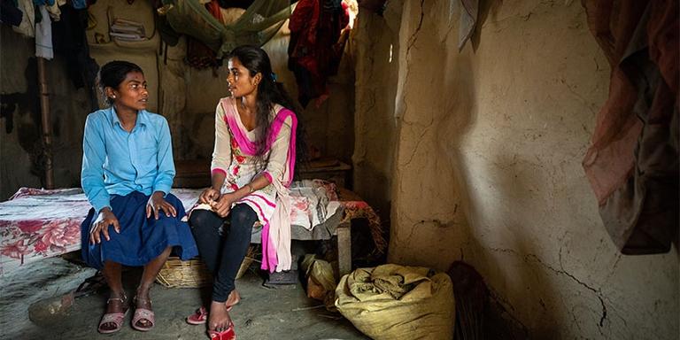 A girl in Nepal speaks with a local aid worker A girl in Nepal speaks with a local aid worker