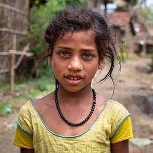 A girl stands outside her home in Nepal. A girl stands outside her home in Nepal.