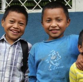 A young boy, Lesbi and his three friends put their arms around each other and smile for the camera at a Save the Children-sponsored school in the mountains of Nicaragua. Photo credit: Save the Children, June 2014. A young boy, Lesbi and his three friends put their arms around each other and smile for the camera at a Save the Children-sponsored school in the mountains of Nicaragua. Photo credit: Save the Children, June 2014.