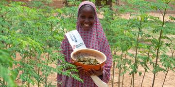 Barira holds a bowl of nutritious moringa grown at her community garden. She leads the fight against child hunger with her local student government. Photo Credit: Talitha Brauer/Save the Children, 2016. Barira holds a bowl of nutritious moringa grown at her community garden. She leads the fight against child hunger with her local student government. Photo Credit: Talitha Brauer/Save the Children, 2016.